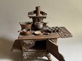 a small wooden stove with pots and pans on it
