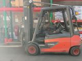 a fork lift truck in a warehouse with boxes on the shelves