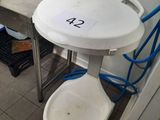 a small table with a bucket on it in the kitchen