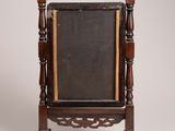 an old wooden frame with a chalkboard on it sitting on a stand