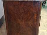 a wooden cabinet with a marble top in a room