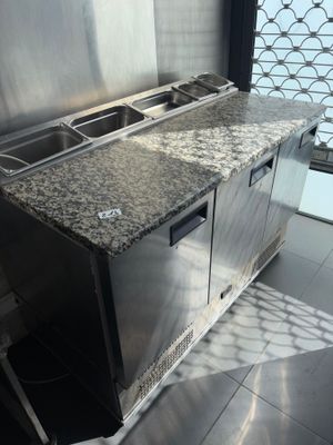 a kitchen with a sink and a counter with two sinks