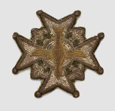 a close up of a star shaped badge on a white surface