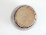 a white bowl with a brown lid sitting on a table