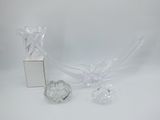 a clear glass vase and a box on a white surface