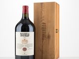 the bottle of wine is next to a wooden box