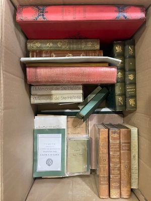 books in a cardboard box are stacked on top of each other