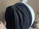 a hat on a table with a lamp on it