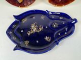 a blue platter with a gold design on it