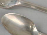 three spoons and a fork on a table