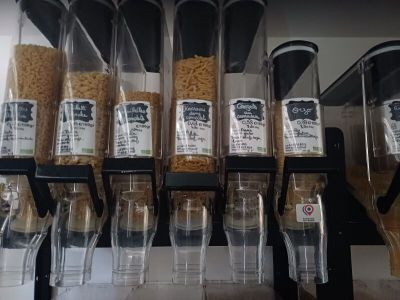 many containers of cereal on a shelf in a store