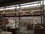 a large warehouse with many tables and chairs in it