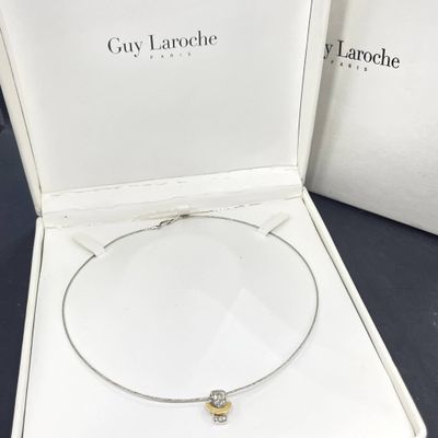 a white box with a silver and gold necklace and a white box with a silver and gold necklace