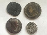 four different types of coins are shown on a white surface