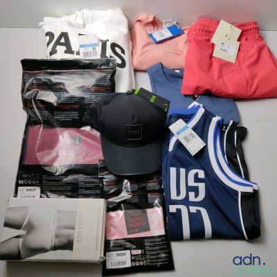 a lot of clothing and a hat on a table