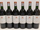six bottles of red wine lined up in a row on a table