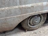 a close up of a dirty car tire on the street