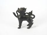 a small statue of a cat with a kitten on it ' s back