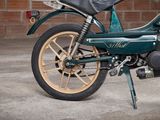 a motorcycle that is parked in front of a brick wall