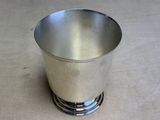a silver cup that is sitting on a table