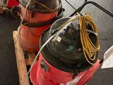 two air compressors sitting on a pallet on the street