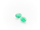 a pair of green quartz faceted tear shaped beads on a white background