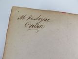 an old book with writing on it sitting on top of a table