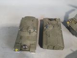 several toy army vehicles are lined up on a white surface