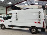 a white van parked in a garage with other vehicles