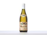 a bottle of white wine sitting on top of a table