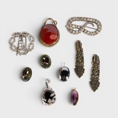 several different types of broochets and jewelry on a white surface