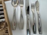 a wooden box with silverware on it next to a knife and fork