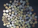a lot of coins that are on a black surface