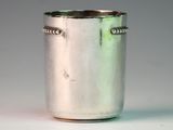 a silver cup that is sitting on a table