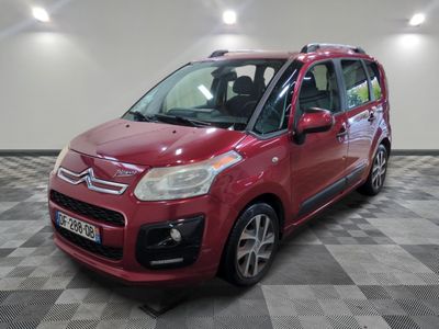 the red citrole is parked on a checkered tile floor