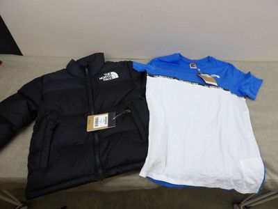 La veste et le t-shirt The North Face sont posés sur un banc