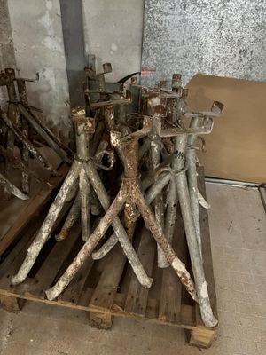 a pile of metal tools on a pallet in a room