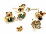 many different types of earrings on a white surface