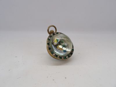an image of a small glass pendant with a gold chain