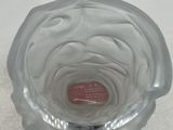 a clear glass bowl with a red label on it