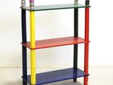 a multicolored shelf with two candles on it