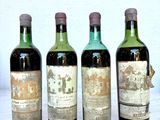 four bottles of wine are lined up on a table