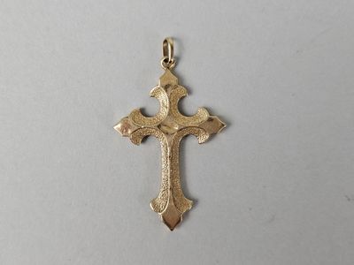a gold cross pendant on a white background