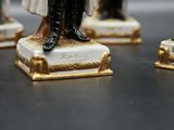 four figurines of men dressed in military uniforms