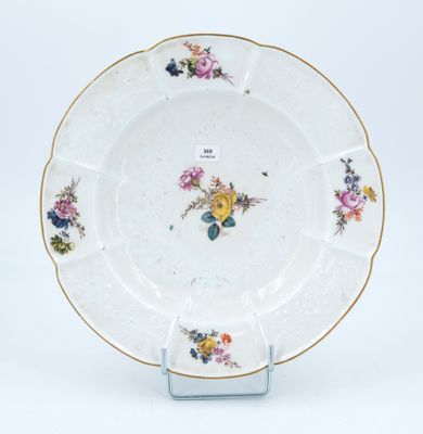 a white plate with flowers on it on a stand
