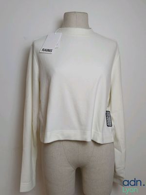 a close up of a mannequin mannequin wearing a white sweater