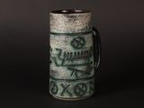 a close up of a cup with a design on it