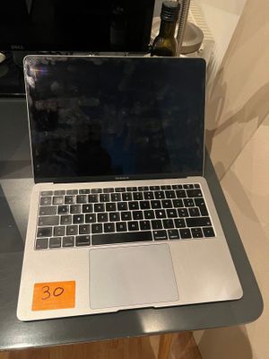a laptop computer sitting on a desk with a price tag on it