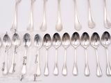 a lot of silver spoons and spoon spoons on the table