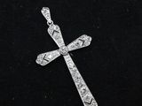 a diamond cross pendant on a black background